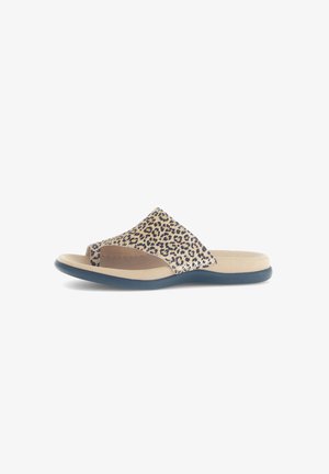 Flat slide sandals featuring a beige upper with a leopard print pattern, soft footbed, and a navy blue flexible sole.