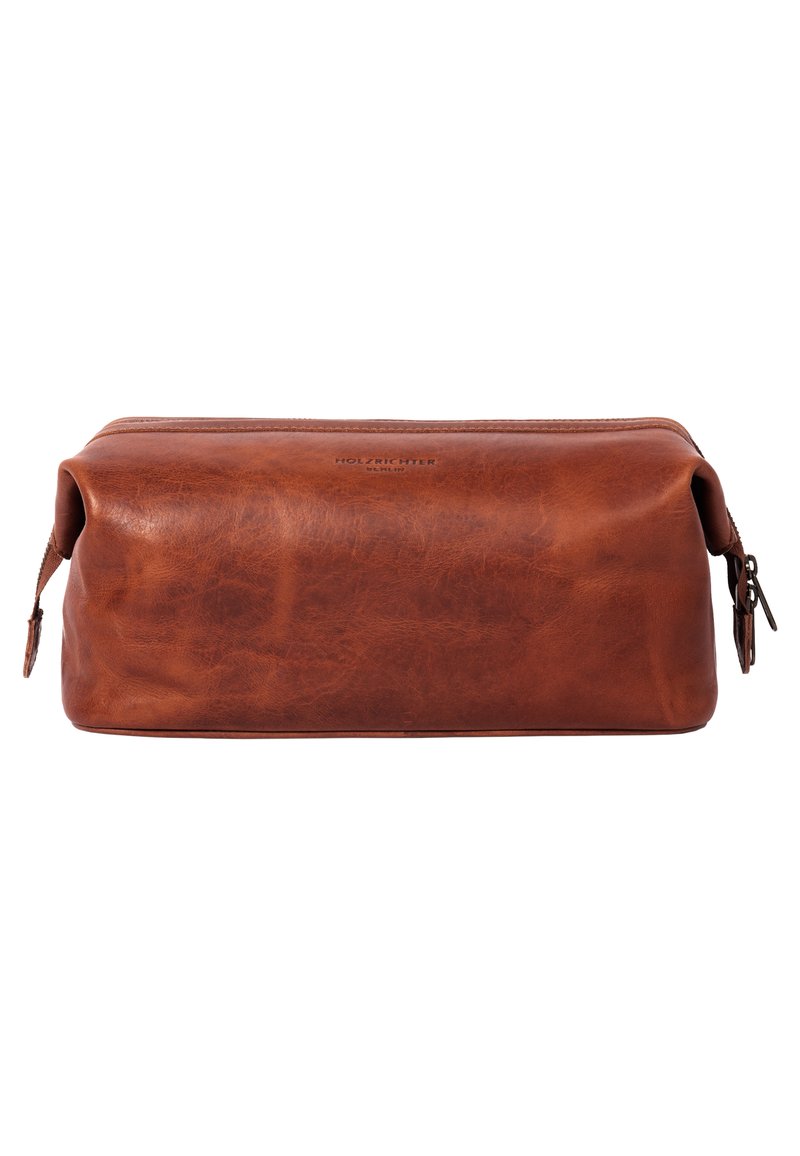 Brown leather toiletry bag with a rectangular shape, smooth texture, and a zippered closure. Features subtle branding on the front.