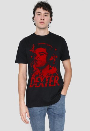 Black cotton t-shirt featuring a red graphic print of a male figure and the word "DEXTER" in bold, distressed lettering.