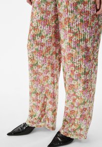 Floral-patterned, wide-leg trousers in multicolor hues of pink, green, and orange, featuring a textured fabric with sequins.