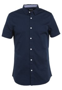 Camicetta a maniche corte blu navy con bottoni bianchi e colletto a punta.