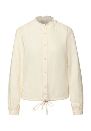 Camicia button-up color crema con colletto a volant, maniche lunghe e fiocco in vita. Realizzata in tessuto morbido e leggero con una texture liscia.