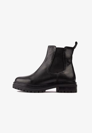 Black leather Chelsea boot featuring elastic side panels, a pull tab, and a chunky textured rubber sole. Smooth finish with stitched accents.