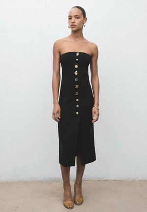 Black strapless midi dress with a front split, featuring gold buttons down the center. Smooth fabric with a fitted shape.
