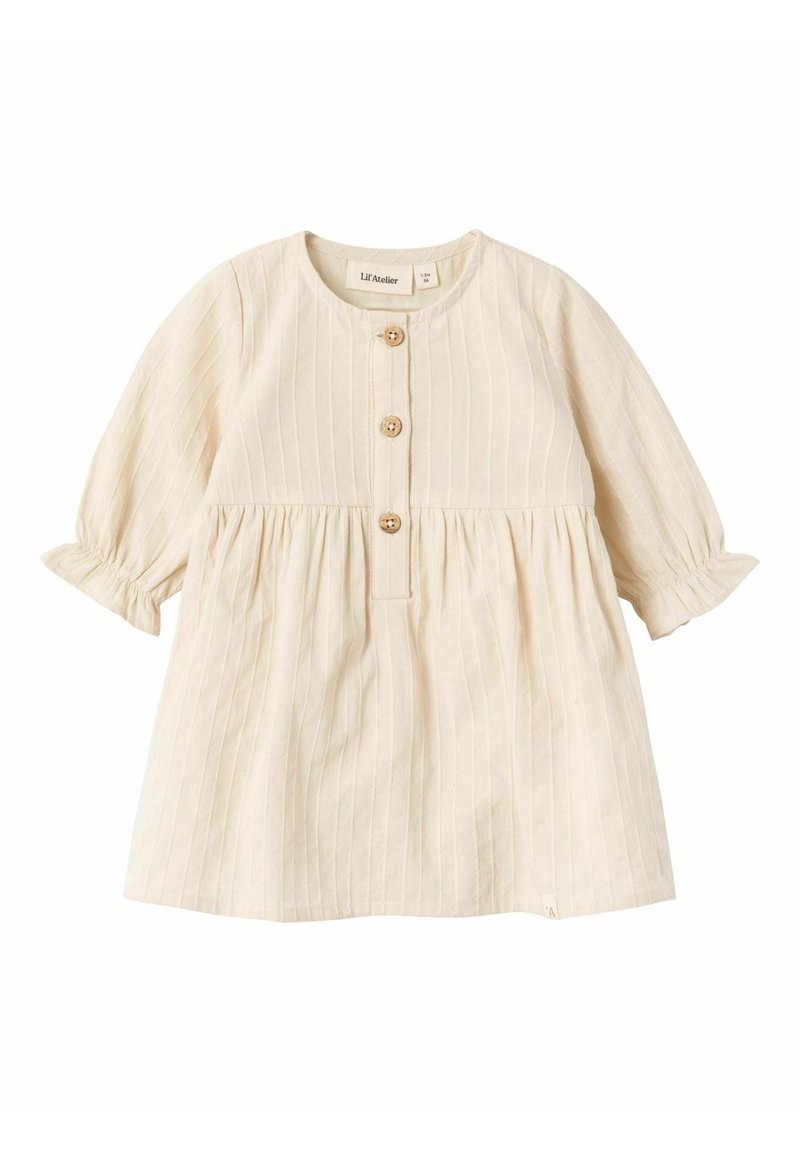 Krämfärgad babyskl�änning med långa ärmar, tre träknappar framtill och en plisserad kjoldetalj.