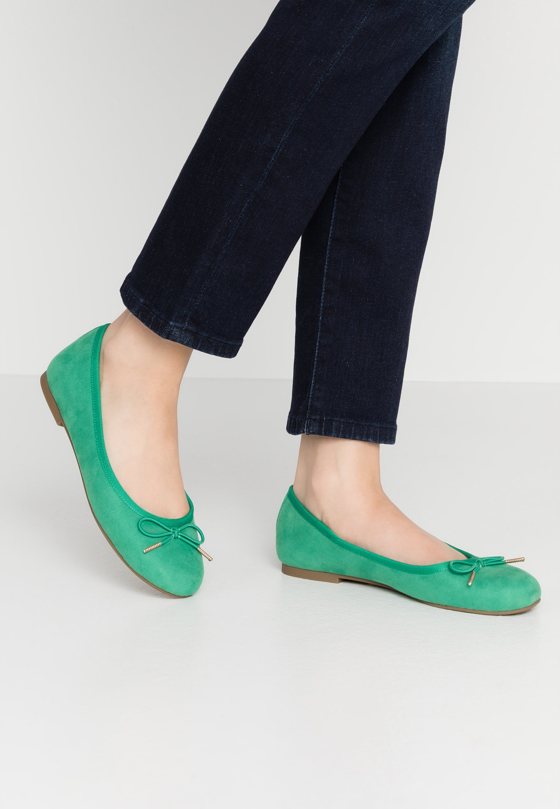 green flat pumps