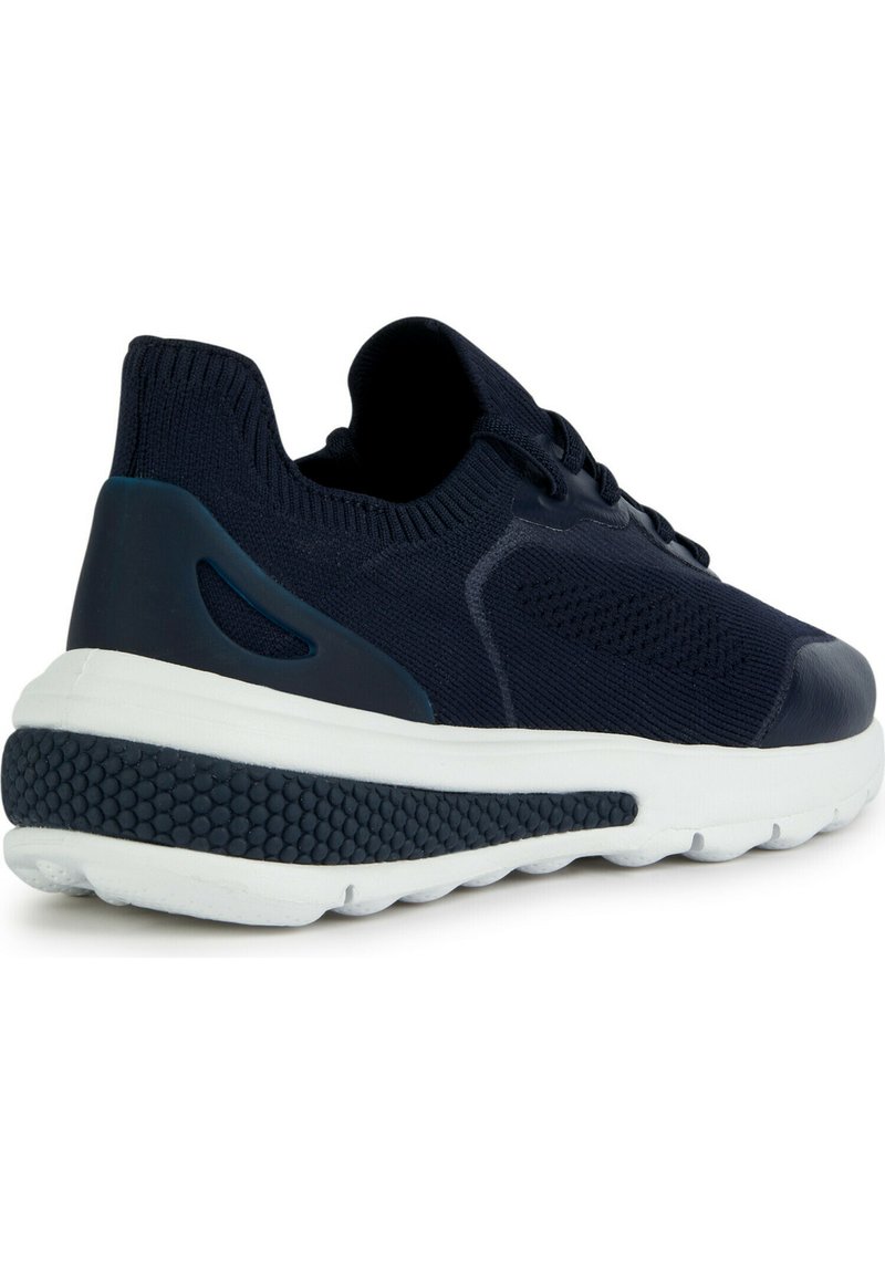 Zapatilla de malla en color navy con parte superior texturizada, media suela blanca acolchada, suela de goma y un eficaz sistema de cordones para un ajuste seguro.