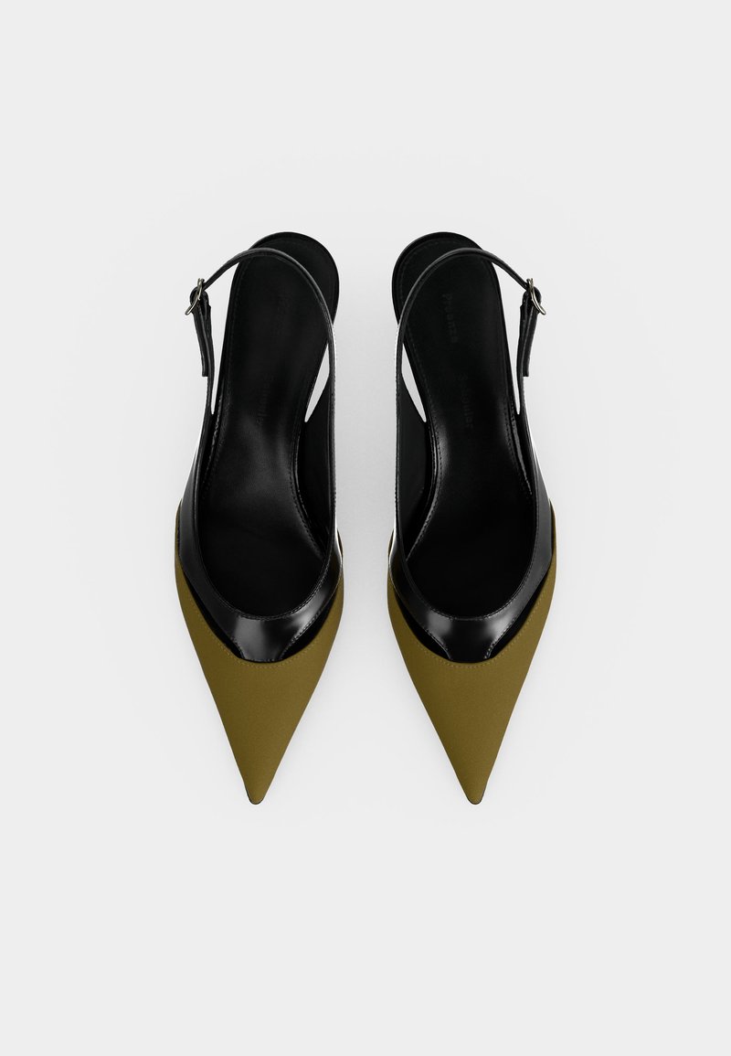 Par dame slingback sko med spids tå i olivengrøn forside og sort læderforing og rem på hvid baggrund.