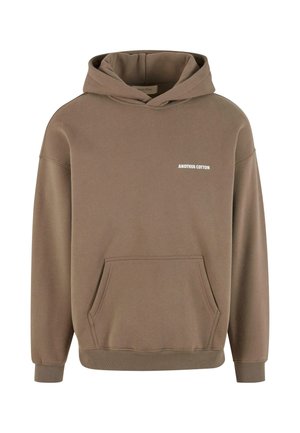 Brown sweatshirt with hood, front pocket, and ribbed cuffs; features white text reading "ANOTHER COTTON" on the chest. Soft fabric texture.