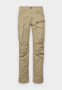 Beige cargo kalhoty vyrobené z odolné bavlněné směsi, s několika kapsami, boční kapsou na zip a rovnými nohavicemi.