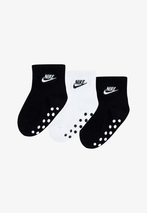 Pakke med tre bomullssokker i svart og hvitt. Har ribbestrikkede mansjetter, Nike-logo og gummidupper under sålene for grep.