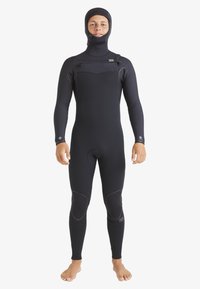 Full-body wetsuit in black neoprene with a hood. Features reinforced knee patches and front zip closure. Designed for cold water conditions.