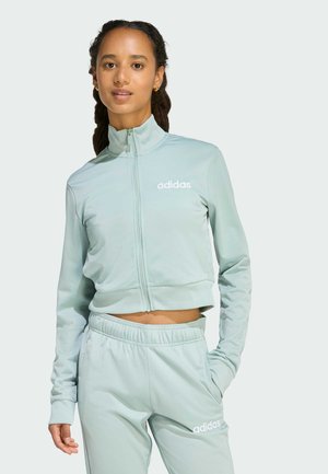 Light green cropped Adidas track jacket with high collar and zip closure, paired with matching pants featuring an elastic waistband and logo.