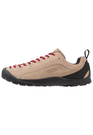 Beige suede low-top shoes with red laces, black rubber sole, and mesh accents near the heel for breathability and comfort.
