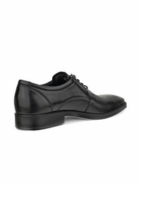 Schwarze Leder-Dressschuhe mit glatter Oberfläche, runder Zehenform, Schnürdesign und niedrigem Absatz. Besitzen subtile Steppdetails an den Seiten.
