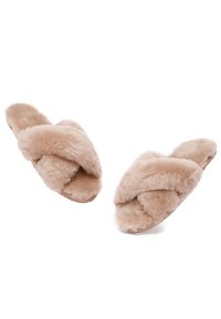 Faux fur slippers in light beige, featuring a crossed upper design. Soft, plush texture with a flat sole.