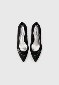 Black suede pointed-toe flats with embellished crystal detailing on the toe. Silver inner lining and branding visible. Smooth texture.