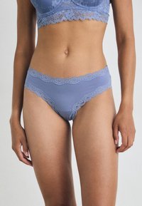 Light blue lace-trimmed briefs with a smooth fabric finish, featuring floral lace accents along the waistband and leg openings.