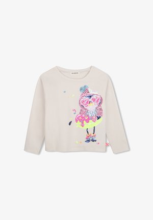 Beige shirt met lange mouwen en een kleurrijk paillettenontwerp van een vogel die een hartvormige bril en een rok draagt.