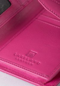 Pink leather wallet with smooth texture, embossed logo "Lakeland Leather," and zip closure. Features internal card slots and simple design.