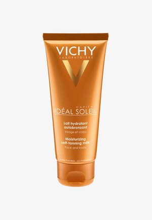 Moisturizing self-tanning milk in an orange tube with a white and gold logo. Text includes product details in French and English.
