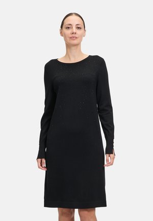 Vestito lungo nero a maniche lunghe realizzato in tessuto morbido, con scollatura a barca, decorazioni sottili e un design a taglio dritto con aperture laterali.