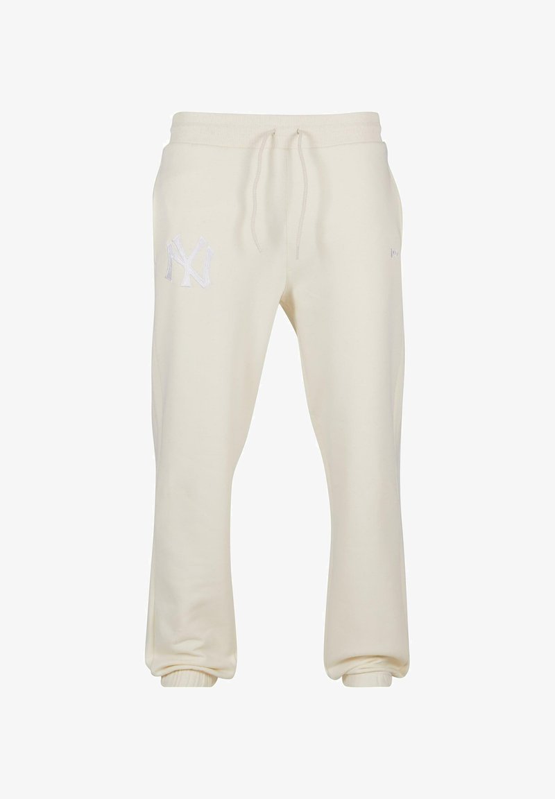 Cremefarvede sweatpants lavet af blødt stof, med elastisk talje med snøre og ribbede manchetter. Dekorativt NY-logo på den ene side.