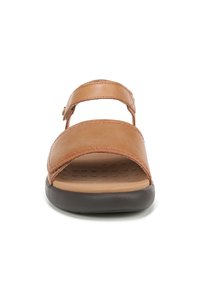 Brown leather sandal with two adjustable straps, a cushioned footbed, and a thick black rubber sole. Textured insole for grip.