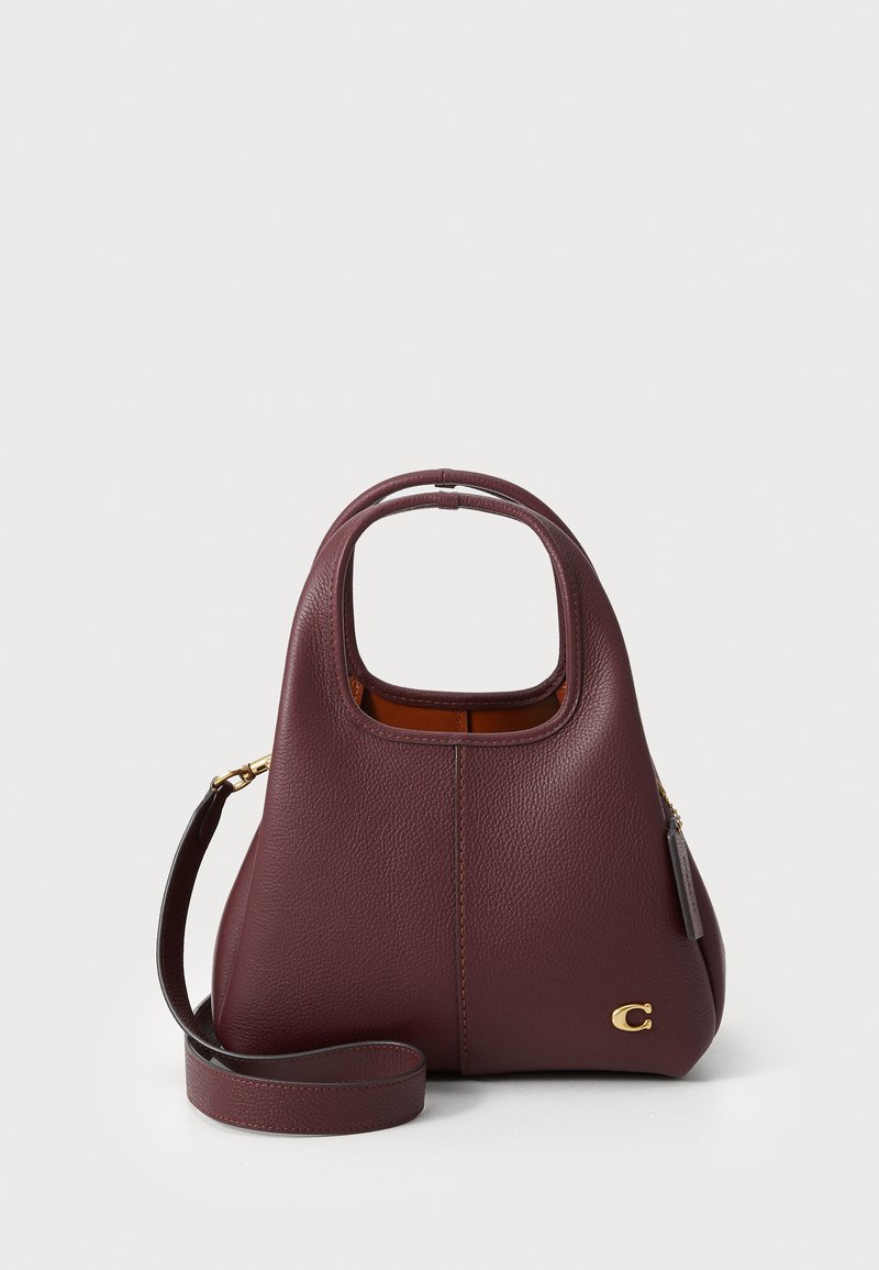 Burgundy leather handbag with a curved top handle, textured exterior, gold logo accent, and detachable shoulder strap.