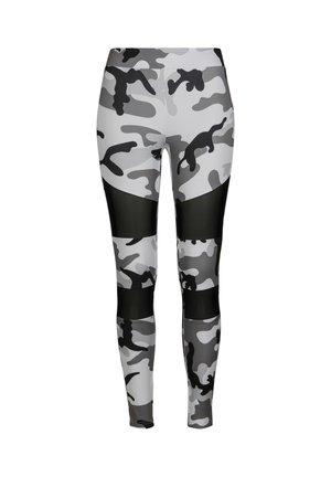 Leggings camouflage en gris et noir. Présentent un tissu extensible lisse, un design ajusté et des panneaux en résille noire transparente.