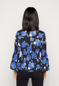 Blumenbluse mit blauen Blumen auf schwarzem Hintergrund, elastischem Bund und Glockenärmeln. Rückseite mit einem Schlüsselloch-Ausschnitt.