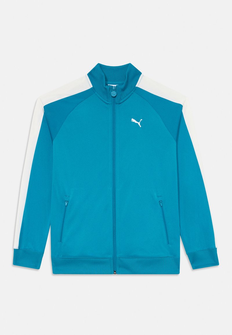 Blå zip-up sportjacka med vita axelaccenter, ribbad krage, två sidofickor och en liten vit logotyp på bröstet.