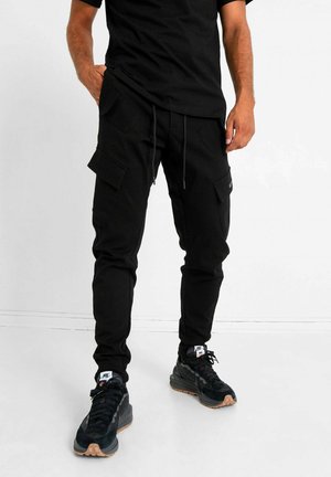 STRETCH - Pantalones cargo - black