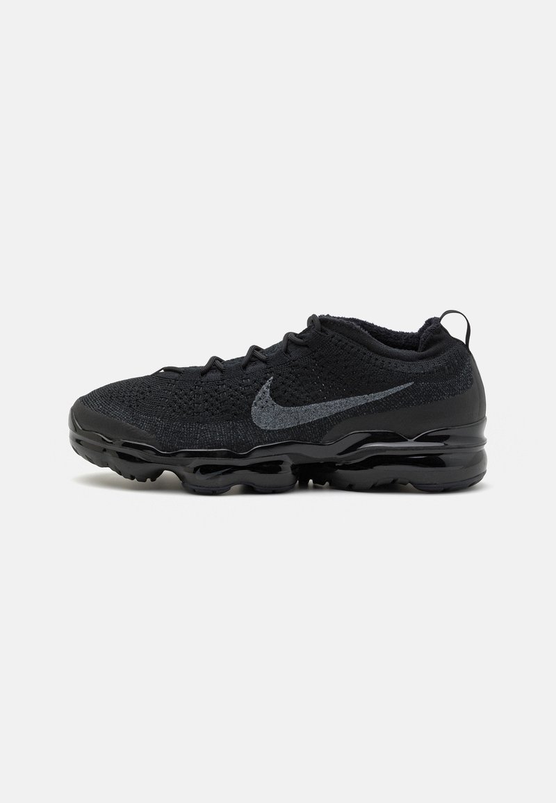 Black Nike athletic shoe with a textured knit upper, featuring a gray swoosh logo, and a glossy black sole with distinct air cushioning.