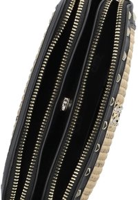 Black and tan wallet with three compartments, gold hardware, and pyramid studs; textured woven material and smooth interior.