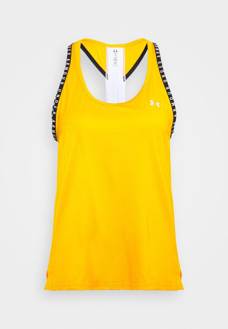 Keltainen urheilullinen toppi racerback-mallilla, mustavalkoiset brändätyt olkaimet, sileä kangas ja hienovarainen kiilto.