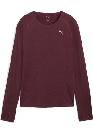 Maglietta a maniche lunghe color bordeaux realizzata in tessuto morbido, con collo a giro e maniche raglan. Piccole perforazioni vicino all'orlo per una migliore traspirabilità.