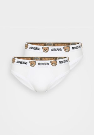 Cuecas de algodão brancas com um cós estampado apresentando um gráfico de um urso e a marca "Moschino" em preto e dourado.