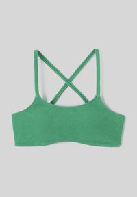 Bralette vert texturé avec des bretelles croisées dans le dos. Finition en tissu lisse, large bande sous poitrine et design sans couture. Style minimaliste.