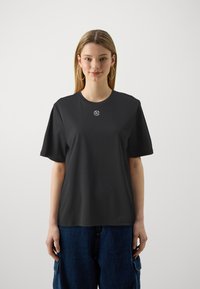 Black crew-neck t-shirt with short sleeves, made of smooth fabric. Features a small, white embroidered logo on the chest.