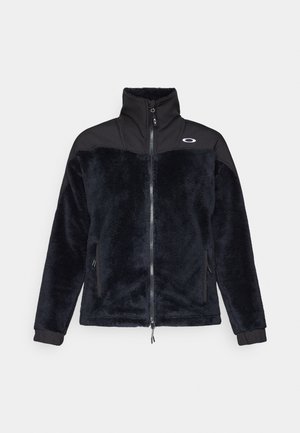 Giacca in poliestere nera con colletto alto, chiusura a zip e tasche laterali; presenta una sezione superiore nera a contrasto e il logo Oakley.