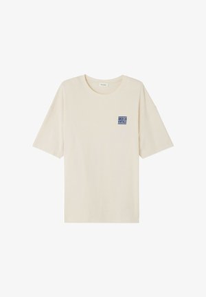 Gai beige kokvilnas T-krekls ar īsām piedurknēm un apaļu dekoltē. Uz krūtīm ir neliels zils "AMERICAN VINTAGE" logotips.