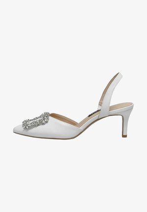 White slingback heels feature a pointed toe, a low stiletto heel, and a crystal-embellished accent on the vamp. Smooth synthetic material.