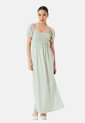 Lys grøn maxi-kjole med pufærmer, smocket liv og blomstermønster. Stoffet ser let og flowy ud, og når til anklerne.