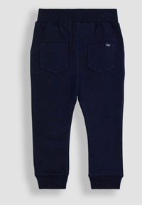 Marineblaue Jogginghose mit elastischem Bund, zwei Gesäßtaschen und gerippten Bündchen an den Knöcheln. Aus weichem Baumwollmaterial.