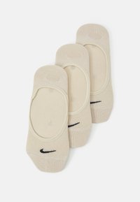 Bež čarape do gležnja od pamučne mješavine s glatkom teksturom, s crnim Nike logom i niskim krojem za diskretno nošenje.