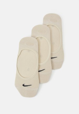 Bež čarape do gležnja od pamučne mješavine s glatkom teksturom, s crnim Nike logom i niskim krojem za diskretno nošenje.