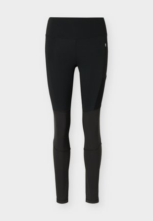 Schwarze Leggings mit hohem Bund, verstärkten Knieeinsätzen und einem kleinen schwedischen Flaggenetikett am oberen Oberschenkel.