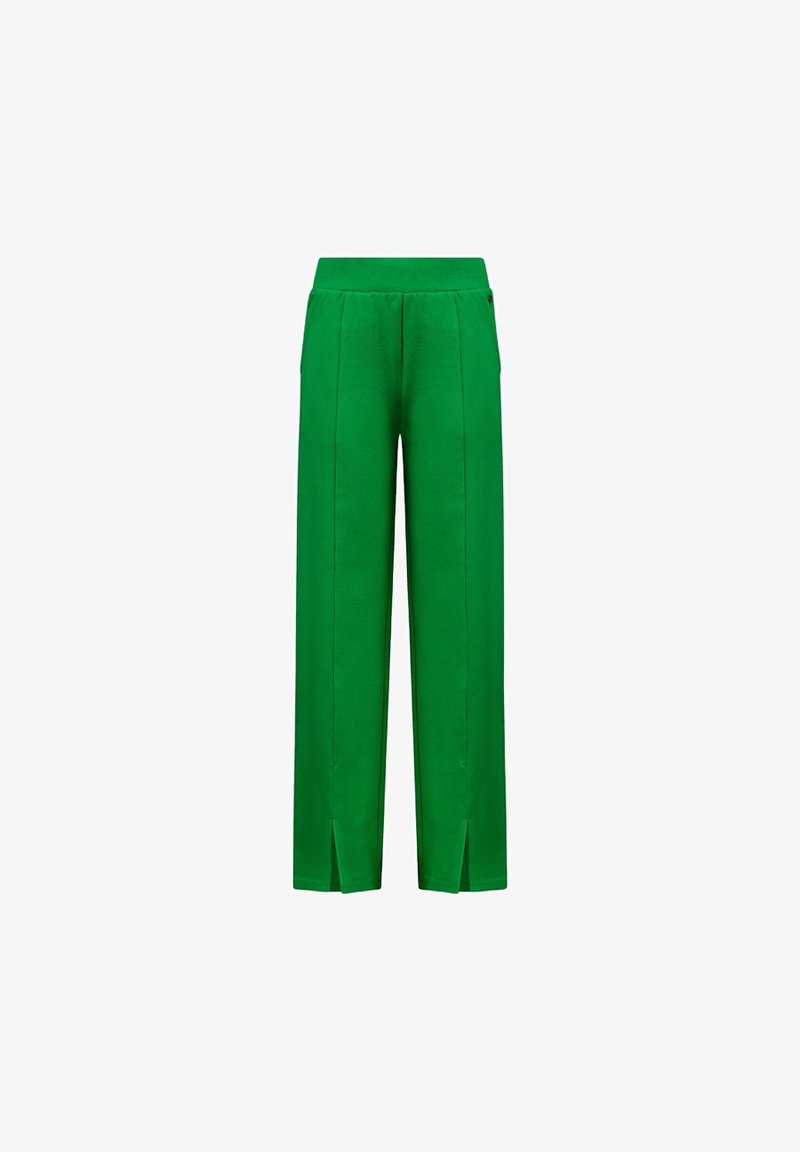 Pantalons larges verts en tissu doux, avec des coutures avant et des fentes sur le bas pour ajouter du détail et permettre des mouvements.