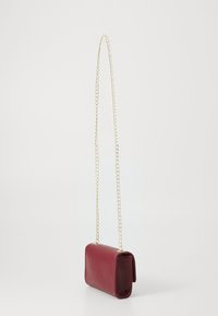 Burgundy leather crossbody bag with a gold chain strap, rectangular shape, textured surface, and a fold-over flap.